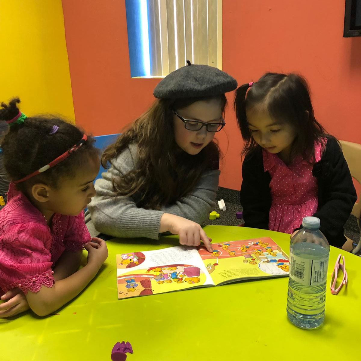 A reader sharing a book with children at church